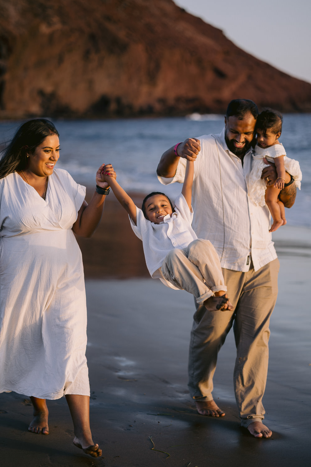 Family with kids playing at the beach in Tenerife
